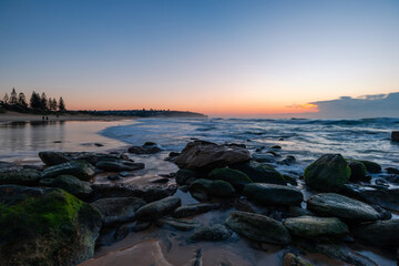 Rocky beach coastline view during sunrise time, Sydney, Australia.