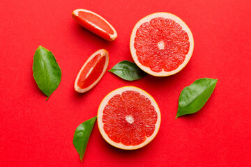 fresh Fruit grapefruit with Juicy grapefruit slices on colored background. Top view. Copy Space. creative summer concept. Half of citrus in minimal flat lay with copy space