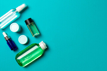 Cosmetics SPA branding mock-up, top view with copy space. set of tubes and jars of cream flat lay on colored background