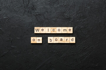welcome on board word written on wood block. welcome on board text on table, concept