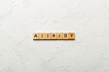 Allergy word written on wood block. Allergy text on cement table for your desing, concept