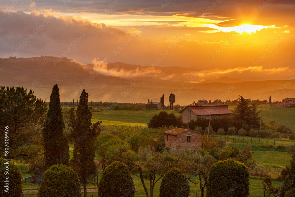 Sticker Sunset over a garden on a farm in Tuscany, Italy