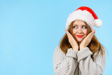 Woman in christmas santa hat on blue