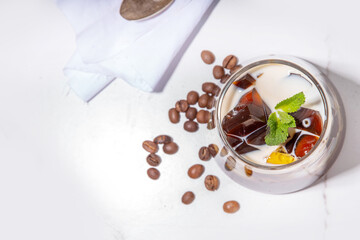 Coffee Jelly Dessert made with strong espresso coffee, gelatin or agar and whipped cream. Asian cold coffee sweets kohii zerii kanten on white table background copy space