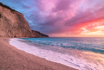Beautiful beach and water bay in the greek spectacular coast line. Sunset gorgeous sky over blue water unique rocky cliffs. Greece summer top travel destination Lefkada island