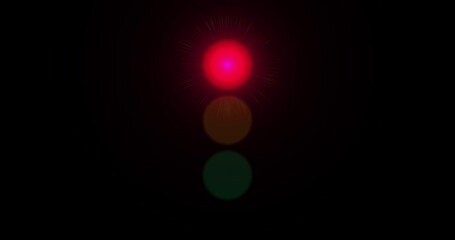 Red, Yellow, Green Traffic Light Changing From Red to Green on Black Background