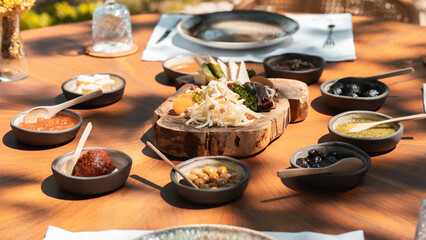 Delicious rich Traditional Turkish breakfast include tomatoes, cucumbers, cheese, butter, eggs, honey, bread, bagels, olives and tea cups. Ramadan Suhoor