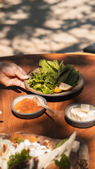 Delicious rich Traditional Turkish breakfast include tomatoes, cucumbers, cheese, butter, eggs, honey, bread, bagels, olives and tea cups. Ramadan Suhoor