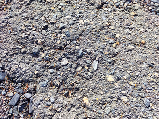 Stone asphalt texture of road. Grey asphalt road and gravel. Background pebble and gravel