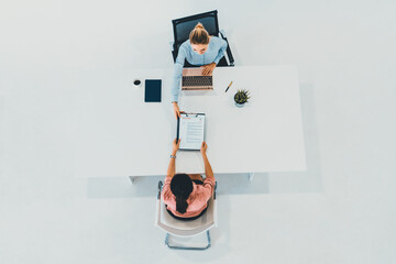 Two young business women in meeting at office table for job application and business agreement....