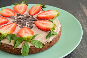 Strawberry oatmeal chocolate cake top with yogurt, shaved chocolate and fresh strawberry