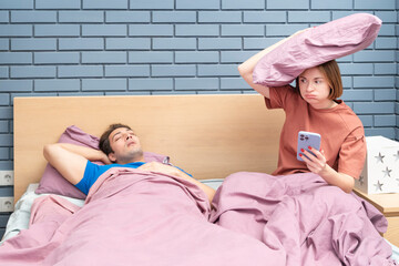 Irritated wife can't sleep because of her noisy husband snoring	