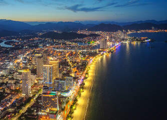 The coastal city of Nha Trang seen from above in the afternoon with its beautiful city and clean sandy beach attracts