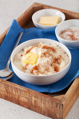 rice pudding with butter cinnamon. french riz au lait, norwegian risgrot, traditional breakfast...