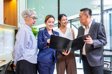 Team of Asian people with different age group brainstorming on data and information analysis for strategy management with young leader for cooperation and business concept