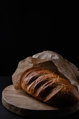 Loaf of bread on a black background. Fresh bakery