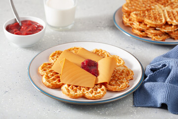 waffles with Norwegian brunost traditional brown cheese and raspberry jam