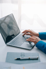 Cheerful business lady working on laptop in office, Asian happy beautiful businesswoman in formal suit work in workplace. Attractive female employee office worker smile.