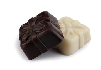  Two beautiful candies made of dark and white elite chocolate isolated on a white background. Art chocolate.
