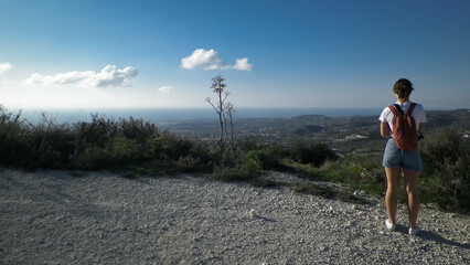 A tourist is walking along a mountain trail.