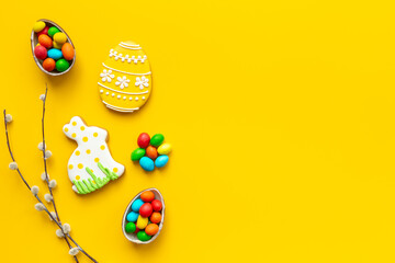 Easter eggs and bunny cookies with spring willow branch. Festive baking cooking flat lay