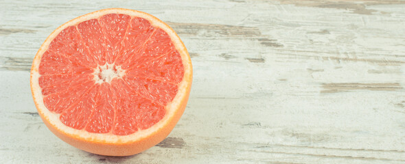 Ripe grapefruit on rustic board. Fruits as source minerals and vitamins. Place for text