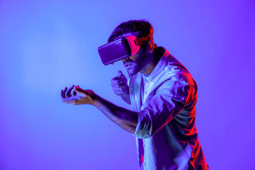 Side view of man wearing VR glass and moving gesture holding gun. Gamer using future digital...