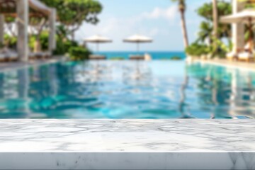 Empty white marble stone table top and blurred swimming pool in tropical resort in summer banner background.  used for display or montage your products.