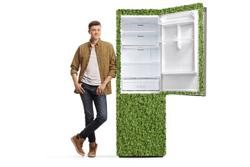 Guy leaning on a green fridge with healthy food products