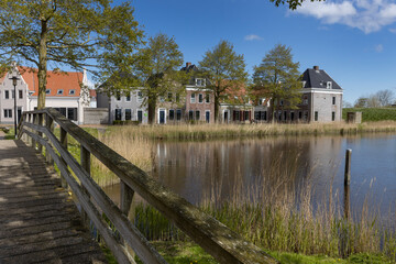 Fototapeta na wymiar Houses and canal at Eson Stad. Eson city. Friesland Netherlands. Replica city. Lauwerszee. Lauwersoog. Waddenzee. 