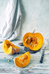Pumpkin slices with seeds on wooden background, selective focus