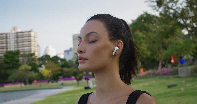 Woman closes eyes in yoga meditation quiet relaxation city park. With each breath female delves deeper into practice of mindfulness meditation power of meditation promote harmony emotional health.