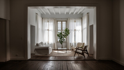 The interior of the room is in the style of minimalism. A room lit by light from a window.