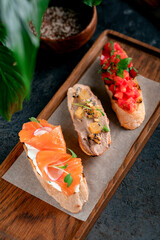 Assorted bruschetta with tomatoes and basil, with pate, with salmon and cottage cheese. appetizers...