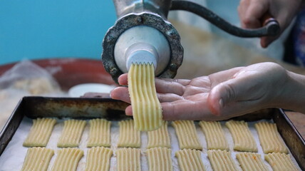 Baking Fresh Butter Cookies: Cookie Dough Extruded from a Press onto a Baking Sheet in Rows