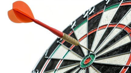 Close view of a dart arrow nailing the bullseye, ideal for illustrating goal achievement and accuracy, isolated setting