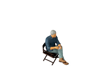 A businessman seated on a chair and sipping hot coffee isolated on white background with clipping...