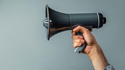 Close-up of an actor's hand gripping a megaphone, conveying intent and passion, isolated against a plain background, studio-lit