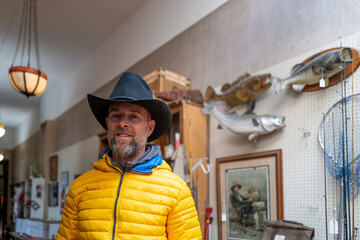 Man wearing cowboy hat at the thrift shop