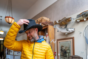 Man wearing cowboy hat at the thrift shop