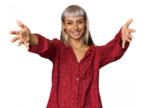 Young caucasian young woman in studio feels confident giving a hug to the camera.