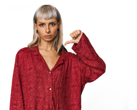 Young caucasian young woman in studio showing a dislike gesture, thumbs down. Disagreement concept.