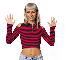 Young caucasian young woman in studio showing number ten with hands.