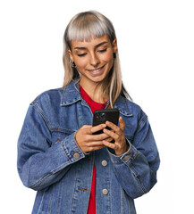 Young Caucasian woman typing on a phone