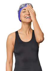 Young Caucasian female professional swimmer laughing happy, carefree, natural emotion.