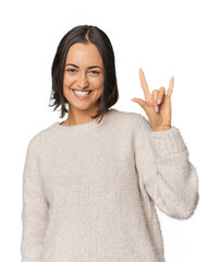 Young Caucasian woman with short hair showing a horns gesture as a revolution concept.