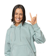 Young Caucasian woman with short hair showing a horns gesture as a revolution concept.