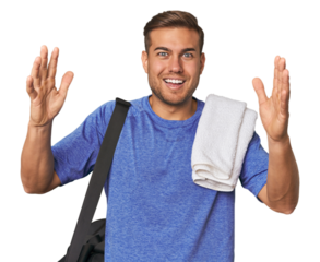 Athlete with gym bag, studio receiving a pleasant surprise, excited and raising hands.