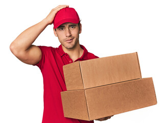 Young Hispanic delivery man with boxes being shocked, she has remembered important meeting.