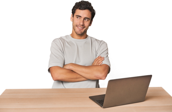 Hispanic young man working on laptop smiling confident with crossed arms.